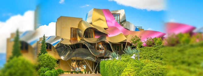 Trip Club Reisen Reisetipps - Marqués de Riscal Design Hotel, Bilbao, Elciego, Spanien. Fantastisch galaktisch, unverkennbar ein Werk von Frank O. Gehry. Inmitten idyllischer Weinberge in der Rioja Region des Baskenlandes, bezaubert das schimmernde Bauobjekt mit einer Struktur bunter, edel glänzender verflochtener Metallbänder. Glanz im Baskenland - Es muss etwas ganz Besonderes sein. Emotional, zukunftsweisend, einzigartig. Denn in dieser Region, etwa 133 km südlich von Bilbao, sind Weingüter normalerweise nicht für die Öffentlichkeit zugänglich.